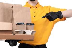 front-view-young-female-courier-yellow-uniform-black-gloves-black-mask-holding-coffee-cups-food-delivery-packages_140725-22112-removebg-preview