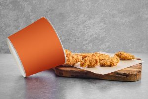 deep-fried-chicken-wings-basket-breading-scattered-parchment-paper_105609-10935