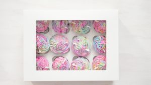 flat-lay-step-by-step-boxing-unicorn-chocolate-cupcakes-into-white-cupcake-box_198639-82133